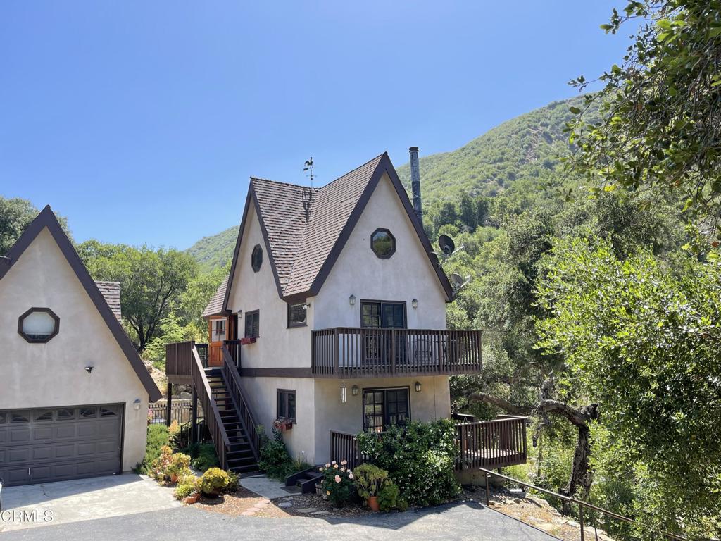 Tucked away in a private canyon a short drive from downtown Ojai, you will find a historical homestead site from the 1800s. The property offers a bit of natural paradise, a Bavarian-style mountain chalet with a year-round flowing stream from an uphill artesian spring. Overlooking the North Fork of Matilija Creek, this is truly a get-away to the serenity of rushing waters and birdsong. The custom-built home offers oak flooring throughout, 2 bedrooms, 2 full bathrooms, and additional living space in a converted garage studio. Built in Bavarian style, one enters a ground floor bedroom with full bath, and doors that open to a deck overlooking the creek below. The 2nd floor living space includes the kitchen and dining area, and another deck to enjoy nature's beauty. A stairway leads to the top floor loft bedroom. Outside you will find a concrete patio with goldfish pond, and above a large koi pond, as well as several picnic areas. The one-hundred-year-old stone walls add to the quaintness. For those who enjoy hiking, this is your property. It is enclosed within the Los Padres National Forest with ample areas for exploration. This property holds a lot of history and is truly one-of-a-kind. You must see it to believe it.