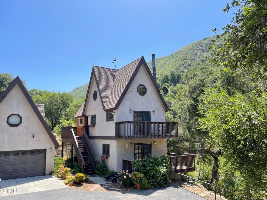 Tucked away in a private canyon a short drive from downtown Ojai, you will find a historical homestead site from the 1800s. The property offers a bit of natural paradise, a Bavarian-style mountain chalet with a year-round flowing stream from an uphill artesian spring. Overlooking the North Fork of Matilija Creek, this is truly a get-away to the serenity of rushing waters and birdsong. The custom-built home offers oak flooring throughout, 2 bedrooms, 2 full bathrooms, and additional living space in a converted garage studio. Built in Bavarian style, one enters a ground floor bedroom with full bath, and doors that open to a deck overlooking the creek below. The 2nd floor living space includes the kitchen and dining area, and another deck to enjoy nature's beauty. A stairway leads to the top floor loft bedroom. Outside you will find a concrete patio with goldfish pond, and above a large koi pond, as well as several picnic areas. The one-hundred-year-old stone walls add to the quaintness. For those who enjoy hiking, this is your property. It is enclosed within the Los Padres National Forest with ample areas for exploration. This property holds a lot of history and is truly one-of-a-kind. You must see it to believe it.