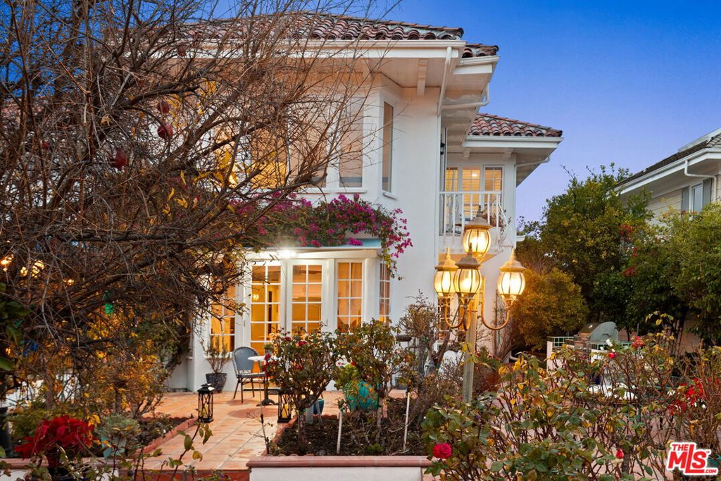 Welcome to your very own Mediterranean mountaintop retreat, behind gates in Brentwood's sought-after Mountaingate community. Wrapped with lush gardens and fruit trees, the home seamlessly blends old-world charm with modern upgrades and amenities. Enjoy canyon, city and ocean views, from the plush cabana, spa tub, various balconies and large windows across the 5,000 square foot residence. On the main level, a newly-built illuminated onyx wet bar connects the foyer with the living and dining rooms, serving as the ideal space for entertaining a large gathering, all crowned with exquisite Baccarat crystal chandeliers. A chef's kitchen with new appliances, expansive center island and abundant storage, spills out to the garden through French doors. A grand staircase leads to a hotel style primary suite complete with a sitting area, private balcony with ocean views, newly renovated spa-like bathroom with freestanding tub and large walk-in closet. Other amenities include an outdoor kitchen with grill and sink, massage room, exercise room, three-car garage, new hardwood floors, and over $600k in recent upgrades throughout. All this, behind gates with 24/7 security and easy access to the golf club, hiking trails, 405 freeway, and the world class dining and shopping of Brentwood and Santa Monica.