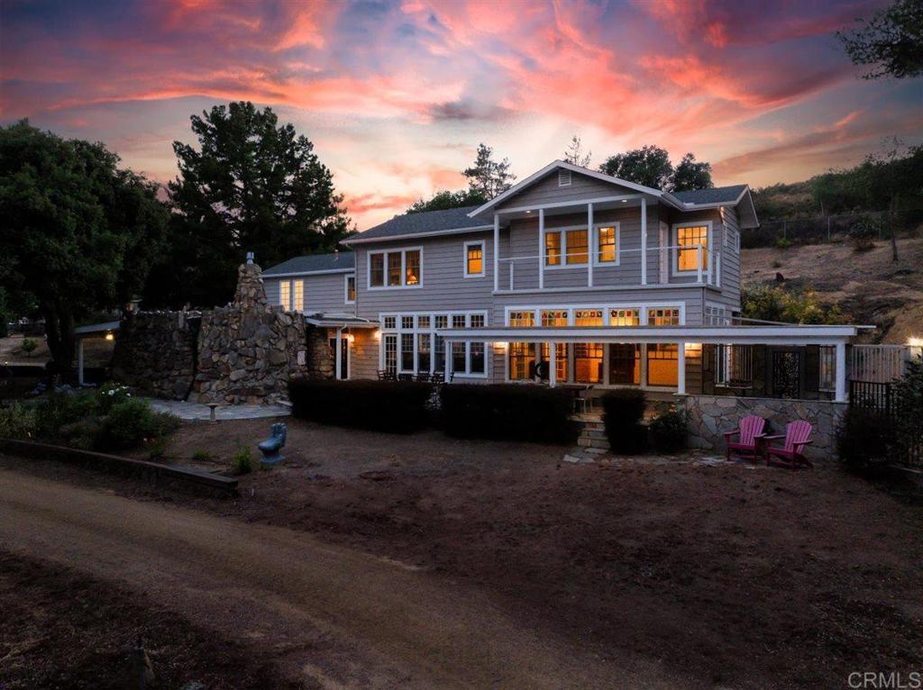 Parklike Ranch Estate on appx 9 Acres. A Natural Sanctuary in Ramona's Exclusive West End. One-of-a-kind estate features a private pond teeming with life, blue gill, bullfrogs, tadpoles, crawdads, turtles, dragonflies, and over 50 species of aquatic, raptor, and perch birds. It’s not just a home it’s your own private nature preserve. 4-stall MD barn with 2 tack rooms, arena, corrals, and fenced pasture 1000 sf workshop/garage Converted silo guest house Separate 3-bedroom mobile home 15' above-ground pool Dozens of fruit trees Well water for irrigation, city water for the home Three gated access points (Highland Valley Road and private easement) The lovingly restored classic 1920s main residence has hardwood and marble floors, beamed ceilings, and artisan finishes throughout. The family room features a wood-burning Xtrordinair fireplace, 8 mullioned windows overlooking the pond. The living room’s gas fireplace crafted with native stones gathered from the property is a showstopper, with hickory hardwood floors. Dream island kitchen with granite countertops, SubZero refrigerator, Viking 6-burner stove, double ovens and walk-in pantry. The primary suite looks over the pond, has two walk-in closets and primary bath with a soaking tub, and walk-in shower. The 2nd bedroom has French doors that open to a balcony patio with views to Mount Woodson (Famed Potato Chip Rock). The third bedroom features a huge cedar-lined closet and its own private balcony overlooking the water. This is the kind of property people dream of finding, peaceful, self-sustaining, and full of charm. This estate is unforgettable.