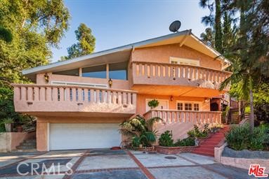 Land, Land, Land, calling all investors and developers—unlock the potential of this private, gated estate nestled on a cul-de-sac tucked away on a private cul-de-sac in the coveted Hollywood Knolls. This gated estate is an ideal fit for those seeking privacy, space, and potential. Set behind a long private driveway on an approx. 15,000 SF lot, this 3-story residence is bursting with opportunity. The layout is versatile with 3 bedrooms, 2.75 baths—including a first-floor bedroom including a 3/4 bath. Kitchen flows to the dining area with a cozy breakfast bar, while the second level boasts a spacious living room with high ceilings, cozy fireplace, and natural light throughout. Upstairs, the primary suite enjoys treetop views from its own balcony, and an en-suite bath offering that peaceful, tucked-away feel, that those who live in the hills love. Multiple balconies, lush greenery, and ample outdoor space make indoor-outdoor living a breeze. Bonus: 2-car garage, generous front yard, and quick access to Warner Bros., Hollywood Bowl, and all major studios and attractions. Location and convenience; it’s what elevates daily life and builds real value. With vision and TLC, this property could become a high-performing asset or a serene city retreat. Serious upside in an A+ location—don’t miss this rare find! Make an appointment to see this little slice of heaven today!