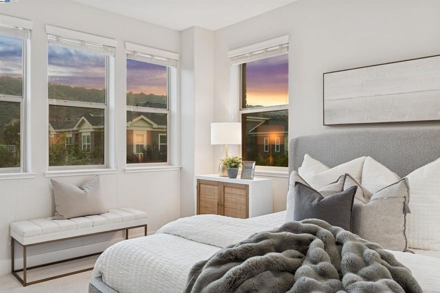Rare opportunity - Township Square development with an elevator! Resort style amenities-clubhouse with pool, spa, fitness center, playground, BBQ, bocce ball court and more! Modeled after the Brownstones in New York, this "like-new" home is a three-story, 4 bedroom, 3 1/2 bath 2856 square foot masterpiece that is easily accessible with a private elevator, ideal for multi-generational living. The home features new carpet, hardwood floors, and 49 windows spanning over three floors making it light and bright. Incredible living options with a large bedroom/office and full bath on the first floor with access to a side yard and easy access to an oversized 2-car garage which is pre-wired for electric car charger and provides maximum  second floor hosts a chef's kitchen complete with extra storage, white quartz countertops, Bosch SS appliances, gas cooktop, oversized island, spacious deck perfect for alfresco dinning. Third floor features the primary suite with a large walk-in closet, updated bathroom, 2 large secondary bedrooms, updated hall bathroom, and an oversized laundry room. Close to top-rated schools, Bernal sports park, fairgrounds, dining/shopping, and downtown. Enjoy views of the Pleasanton ridge & designated open space. Convenient access to I-680, I-580, ACE, and BART. Views:  Ridge