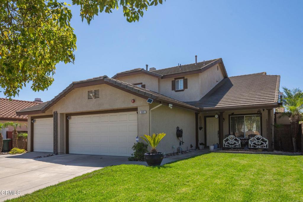 Welcome to this stunning two-story home in the highly sought-after Windrose Pointe neighborhood of Oxnard--perfect for those who love to entertain and enjoy comfortable, coastal living. This delightful home offers 4 bedrooms, 3 bathrooms, over 1,900 sq ft of living space on a 5,900+ sq ft lot, plus an attached 3-car garage and excellent curb appeal. As you step inside to reveal an inviting formal living room with vaulted ceilings, large windows with plenty of natural light, wood-like vinyl flooring that opens to the formal dining area with a large window overlooking the backyard. The heart of the home is the beautifully upgraded kitchen, showcasing quartz countertops, stainless steel appliances with newer dishwasher, an abundance of cabinet space, and a breakfast bar area that opens to the family room area with a lovely brick fireplace and mantle and a door that leads to the nice backyard. Step outside to a private backyard with outdoor sheds for extra storage and a fenced dog run. A bedroom and full bathroom are conveniently located on the main level perfect for guests or multi-generational living. The upper level features a spacious primary bedroom complete with an en-suite bath, double sinks, and a walk-in closet. Two additional bedrooms and a full bath provide ample space for family or guests. Additional highlights include an indoor laundry area for added convenience and window shutters or coverings for privacy and light control. Throughout the home, wood-like vinyl flooring is complemented by cozy carpeting, ensuring comfort and style in every room. Enjoy your morning coffee on the inviting front porch. Located just minutes from South West Community Park, Sea Air Park, beautiful Oxnard beaches, shopping, and dining, this home offers the perfect blend of comfort, convenience, and coastal living. Don't miss the opportunity to make this wonderful home yours!