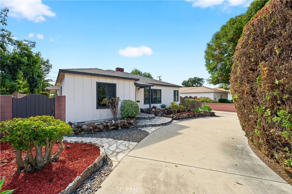 Tired of plain, boring “modern” homes? How about one that captures the charm and craftsmanship of classic times while blending in fresh, tasteful modern touches? Well, look no further! Welcome to 509 N Buttonwood St, a beautifully remodeled Anaheim family home offering 3 bedrooms, 2.5 bathrooms, and 1,846 square feet of living space. Originally built in 1952, this residence has been completely updated from top to bottom while still preserving its timeless character. From the moment you arrive, the U-shaped driveway and extended side driveway set the stage for comfort, practicality, and even ADU potential (yes, you read that right). Inside, you’ll find a spacious living room with soaring vaulted wood-beamed ceilings, a striking stone fireplace, and abundant natural light. The dining area flows into a fully remodeled kitchen featuring stainless steel appliances, quartz countertops, a custom tile backsplash, and self-closing cabinetry and drawers. Every bathroom has been reimagined with new vanities, faucets, toilets, and beautifully tiled showers. Fresh paint, new doors, upgraded flooring, and recessed lighting tie the entire home together with a clean, modern feel. Did I mention the LAUNDRY room is inside? The primary suite offers comfort and style, while the secondary bedrooms provide flexibility for family, guests, or a home office. Step outside to a private, low-maintenance backyard, ideal for entertaining or enjoying quiet evenings. A detached two-car garage, U-shaped front driveway, and gated side driveway provide generous parking options. Major improvements include a brand-new roof and brand-new electrical panel, giving you true peace of mind. To make things even easier, the seller is including Section 1 termite clearance and a one-year home warranty (buyer’s choice). Perfectly located near Disneyland, Anaheim Stadium, shopping, dining, schools, and major freeways, this home offers the best of convenience and lifestyle in a welcoming neighborhood. With its thoughtful upgrades, inviting layout, and true blend of character and modern style, this is not just another house—it’s a family home ready for its next chapter, just in time to celebrate the holidays.