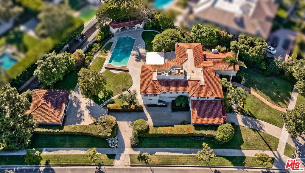 Offer deadline set for Thursday July 27th at 7PM. Email to request the mandatory offer submission package beginning on Monday July 24th. Trust Sale. This magnificent and lovingly maintained Deco-era 2sty Spanish estate with original 1930 design by local master architect, James Dickason, is available for the first time in 51 years. Set on an impressive and rare 26,500 square foot corner lot with 190 feet of rear width, the possibilities are endless for the home's fortunate new owner. Grand scale rooms and a wonderful entertainment flow featuring high ceilings, stained glass, wood and tile floors. Baronial tiled entry foyer with dramatic sweeping staircase leads to enormous beamed-ceiling formal living and dining rooms along with a family room highlighted by a cool pecky-wood clad bar and fireplace. 3 huge sunlit bedroom suites are upstairs including an owner's suite with two walk-ins, office, and bucolic garden and peek-a-boo treetop views. Maid's quarters along with a large guest suite/office are downstairs. Kitchen with separate butler's pantry displays wonderful authentic tilework. Big breakfast room flows to a separate sunroom opening to the massive grounds with patios, lawns, mature foliage, dual cabana baths, and a large 1sty guest facility (appx 850 SF) with great room, storage rooms, bedroom, and bath. Majestic curb appeal on one of Beverly Hills Flats' most coveted Westend 800 blocks enhances the truly tremendous opportunity presented here.