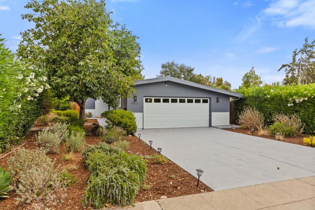Just steps from Robles Park, this bright and beautifully updated home embraces mid-century modern design with warm, inviting interiors and exceptional indoor/outdoor flow. Walls of glass, wide-plank floors, and a striking brick fireplace enhance over 2,000 square feet of stylish living space featuring a spacious living room, open-concept kitchen with high-end appliances from Wolf and Bosch, and a walk-out family room ideal for everyday living. Three comfortable bedrooms are anchored by the expansive primary suite with a soaking tub and separate shower, while the peaceful backyard offers a quiet retreat beneath mature trees. Enjoy easy access to parks, shopping and dining in The Village at San Antonio Center, and a 10-minute drive to downtown Palo Alto, all within the boundaries of acclaimed schools including Briones Elementary, Fletcher Middle, and Gunn High (buyer to verify eligibility).