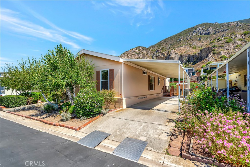 Rarely on Market! This is the first newer Manufactured Home to come on the market in recent years in Camarillo Springs where the you own the land! Built in 2005 this lovely manufactured home has an open floor plan with 3 bedrooms and 2 baths and indoor laundry and lush landscaping along with drip water system and fruit trees. Located in the lovely gated senior community of Camarillo Springs, this home is wonderfully situated with beautiful mountain views and is near a golf course. Property includes additional storage shed and is A/C ready, but who needs it with the temperate Camarillo climate and ocean breeze? Additionally, there is a community pool and clubhouse!