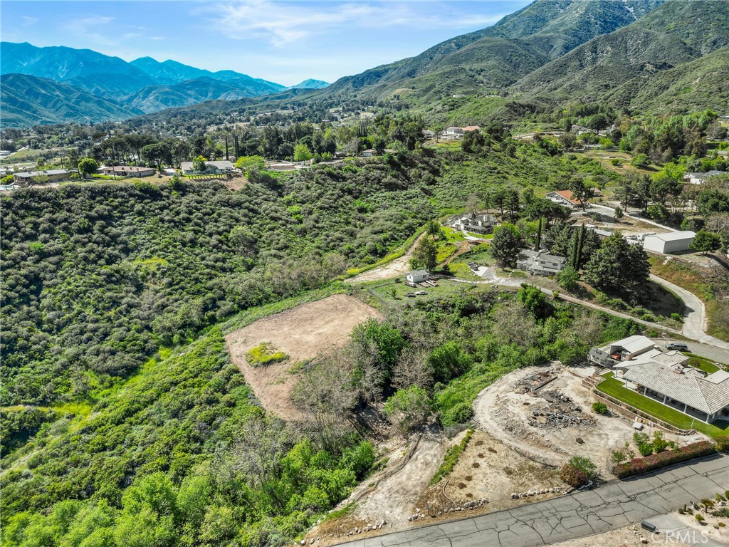 Unlock the potential of this incredible 2.45-acre parcel nestled in the hills of Devore. With easy access and sweeping views of the mountains, valleys, and city lights, this buildable lot offers a rare opportunity to create a custom home or private retreat surrounded by nature. Power and water are available to connect to, making it even easier to bring your vision to life. The property offers a peaceful, rural setting while remaining just minutes from the freeway, shopping, and other conveniences. Surrounded by custom homes and open space, this lot combines seclusion with accessibility. Buyers to satisfy themselves with all aspects of zoning, land use, utilities, boundaries, and building requirements.