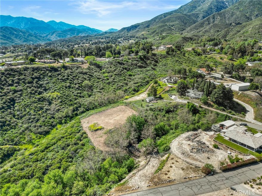 Unlock the potential of this incredible 2.45-acre parcel nestled in the hills of Devore. With easy access and sweeping views of the mountains, valleys, and city lights, this buildable lot offers a rare opportunity to create a custom home or private retreat surrounded by nature. Power and water are available to connect to, making it even easier to bring your vision to life. The property offers a peaceful, rural setting while remaining just minutes from the freeway, shopping, and other conveniences. Surrounded by custom homes and open space, this lot combines seclusion with accessibility. Buyers to satisfy themselves with all aspects of zoning, land use, utilities, boundaries, and building requirements.