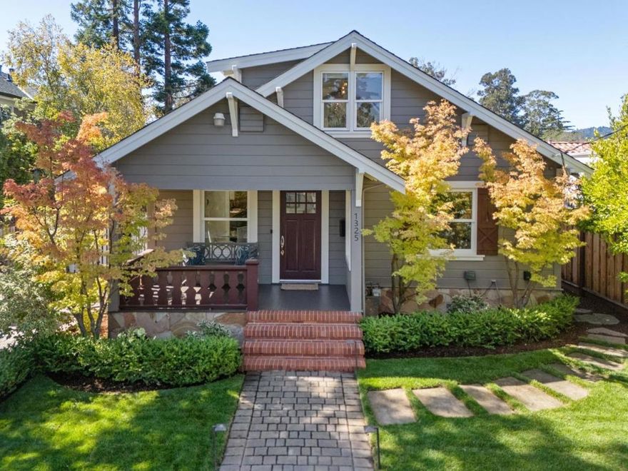 Happy Birthday Paloma! Set on a spacious 6000sf lot just two blocks from the Broadway downtown, this sturdy, well-built 1925 bungalow feels cottage-charm-cozy but lives large! Customize this array of flexible spaces to create the multifunctional home environment that you need now and tomorrow. The main level includes living and dining rooms, a big kitchen and adjacent laundry room, the large primary suite retreat with its vaulted ceiling, walk-in closet and sunny en suite bath, two additional bedrooms, one of which is currently used as an office, and a hall bath. Upstairs are two additional rooms and a half bath - bedrooms, playroom, office ... you decide. A bonus room behind the detached garage is a quiet office or lively rec room. Upgraded systems include owned solar and AC. The west-facing backyard is private, sheltered and sunny, with giant hydrangeas filling the corners like cheerful old friends. Celebrating her centennial, 1325 Paloma is friendly, gracious, and in her groove, the keeper of countless moments and a true Burlingame classic.