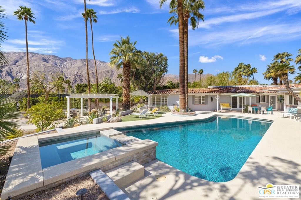 Welcome to 365 Camino Norte - a rare opportunity to own a piece of Hollywood history! This 1936 Spanish-style home, once owned by actress and singer Mary Martin, is on the market for the first time in nearly 36 years. Nestled in the prestigious Old Las Palmas neighborhood, this stunning 6-bedroom, 5-bathroom property spans .68 acres stretching from Camino Norte on the north to Vereda Norte on the south. Truly a high pride of ownership throughout! From the mature landscaping to the resort-style pool and spa, this home invites relaxation and enjoyment all while showcasing breathtaking mountain views that can be seen from nearly every room, both inside and out. Significant upgrades include five HVAC units, paid-for solar panels, and recent improvements to the Pebble-Tec pool and spa. Inside, you'll find a formal living room with exposed beams, built-in speakers, a cozy fireplace, and gorgeous hardwood floors that continue into the south-facing casual dining area. The separate family room, also with stunning views, provides seamless access to the pool and private backyard perfect for entertaining. The kitchen features built-in appliances, a counter bar with seating, a workstation, and a dining area with banquet-style seating, all bathed in natural light with easy outdoor access. The south-facing Primary Ensuite offers views, direct pool and spa access, a large walk-in closet, and a private bath with a shower and tub. A connected retreat (formerly a bedroom) offers its own views, closet, access to the pool, and a private bath with a walk-in shower. Two additional bedrooms share a large walk-in shower in a beautifully appointed bath. On the opposite side of the house, a large bedroom with views, a built-in Murphy bed, access to the pool, and a private bath with dual sinks, a walk-in shower, and a separate soaking tub awaits. A separate Guest House with a private yard and entrance includes views, a dry bar, a walk-in closet, and its own private bath. Rooftop deck, too! Truly a one-of-a-kind opportunity don't miss out on this gem!