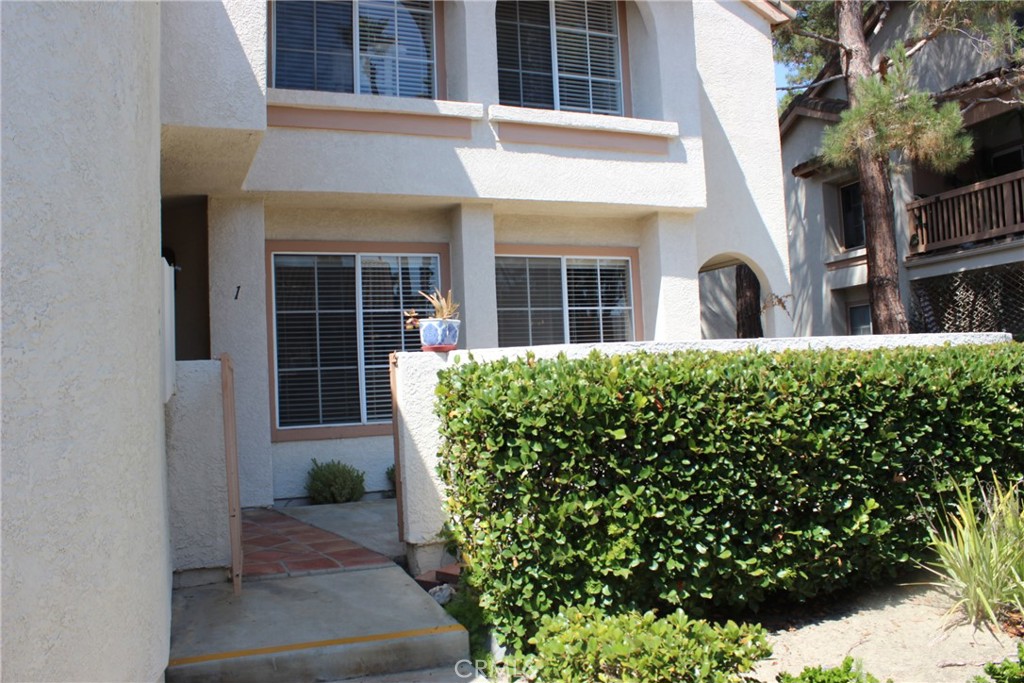 Beautiful property great interior location but near parking. Lower unit with huge wrap around patio area end unit. Newer dark laminate flooring, nice fireplace in living room-tiled decor, slider door leading to side patio area. Bedroom has large walk in closet, bathroom has granite counters, seperate area with stacked washer and dryer. Great location near shopping