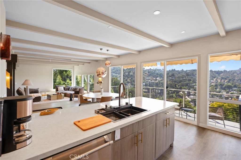 Perched in the coveted Hollywood Hills, this newly remodeled 3-bedroom, 4-bathroom residence seamlessly blends timeless mid-century modern design with contemporary luxury. Boasting over 2,100 square feet of exquisite living space, this home offers breathtaking canyon views and an elevated lifestyle. Step inside to discover a sophisticated interior featuring brand-new kitchen cabinets, Silestone countertops imported from Spain, and top-of-the-line Thermador appliances—a chef’s dream. Custom designer closets, premium hardware finishes, and statement Tom Dixon light fixtures enhance the home's modern aesthetic. The spacious bonus room provides endless possibilities, whether as a media lounge, home office, or gym. Don't miss this rare opportunity to own a meticulously curated mid-century masterpiece in one of Los Angeles’ most sought-after neighborhoods!