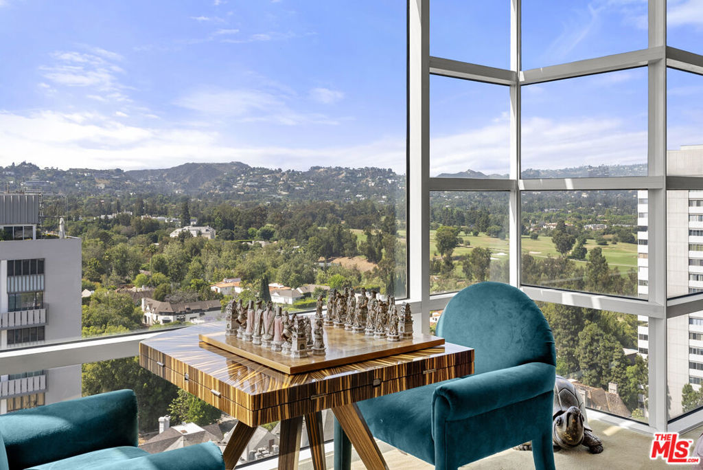 Northwest corner unit on the 15th floor with open floor plan and panoramic views from all rooms. This spacious 3,143 s.f. 3-bedroom, 3.5-bathroom, residence features approx. 11-foot floor-to-ceiling windows showcasing spectacular views of the mountains, LA Country Club, and city lights. Custom cabinetry and built-ins throughout create an elegant living environment. The primary suite boasts two custom walk-in closets and a spa-like bathroom. Gourmet Poggenpohl kitchen with breakfast area opens to one of two large balconies, perfect for entertaining. Separate laundry room with service entrance adds convenience. The private elevator lobby serves only two units per floor, ensuring maximum privacy and exclusivity. Located in the prestigious La Tour, one of Wilshire Corridor's finest full-service buildings featuring 24-hour valet parking, concierge services, doorman, heated pool, state-of-the-art fitness center, and conference facilities. Just minutes from Beverly Hills, Century City, and UCLA.