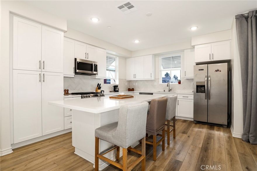 Welcome to Resort-Style Carson Landing!
Built just a couple of years ago, this community offers premium amenities and an unbeatable location near Cal State Dominguez Hills—perfect for owner-occupants, investors, or those seeking excellent income potential for student or educator housing.

This top-level 2 bed / 2.5 bath corner condo features soaring ceilings, no neighbors/shared walls above or beside you, and an abundance of natural sunlight. The open, airy floor plan includes luxury vinyl plank flooring, a spacious formal dining area, and a large private balcony ideal for morning coffee, grilling, or simply relaxing outdoors.

The bright, modern kitchen boasts Quartz countertops, a stainless steel farmhouse sink, soft-close white shaker cabinets, lightly used stainless steel appliances, and a generous island—perfect for cooking, entertaining, or gathering with friends.

Both bedrooms are thoughtfully positioned on opposite sides of the home for maximum privacy—ideal for roommates or rental income. The primary suite includes a walk-in closet and an elegant en-suite bathroom with Quartz counters, custom cabinetry, and a spa-like step-in shower.

On the entry level, you'll find an oversized 2-car tandem garage with epoxy flooring, a tankless water heater, ample storage space, and a dedicated outlet ready for an EV charger.

Just steps from your front door is the community’s impressive resort-style amenity center, featuring a sparkling pool, spa/Jacuzzi, BBQ grills, fire pit, outdoor showers, bathroom facilities, and a beautiful recreation room—perfect for entertaining, working from home, business meetings, or spending time with neighbors.

Close to CSUDH, major freeways, and the Beach Cities, this home offers one of the best values in the South Bay. Don’t miss this incredible opportunity!