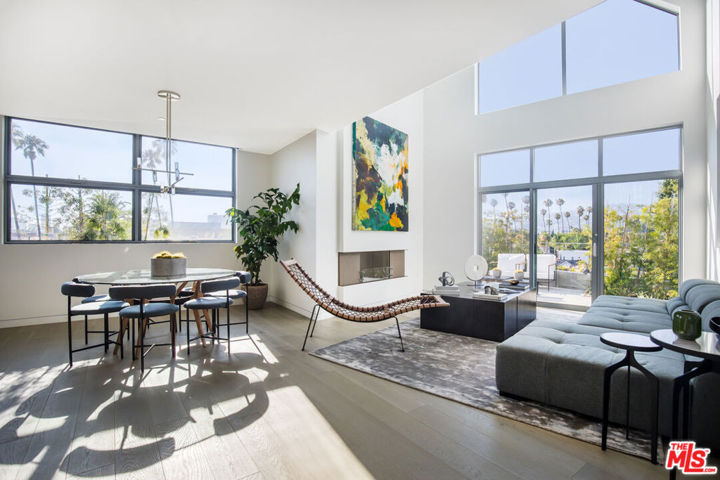 Experience rare elegance in the heart of Beverly Hills with this exceptional duplex residence, which seamlessly blends expansive space, privacy, and contemporary design. Spanning two levels, this home offers the ultimate in convenience with a private in-unit elevator, a feature rarely found in the market. Flooded with natural light from floor-to-ceiling windows, the interiors feel open and airy, while offering stunning views of the hills that frame an unforgettable backdrop. The main level boasts a spacious living and dining area, designed for both casual living and upscale entertaining, complemented by a chef's kitchen featuring top-of-the-line appliances, sleek cabinetry, and premium finishes. Upstairs, retreat to oversized bedrooms bathed in soft sunlight with custom closets and spa-inspired bathrooms, where luxury meets tranquility. Every detail reflects refined craftsmanship, creating a serene escape within the city. Private outdoor terraces offer the perfect vantage point for savoring morning coffee or enjoying sunset gatherings overlooking the scenic hills of Beverly Hills. Combined with its duplex layout and elevator, this home offers the feel of a private estate with the perks of a luxury building. Located moments from world-class dining, designer boutiques, and cultural hotspots, this residence delivers a lifestyle defined by sophistication, privacy, and convenience. Premium amenities, concierge services, and secure access complete the experience, making this a rare offering in Beverly Hills.