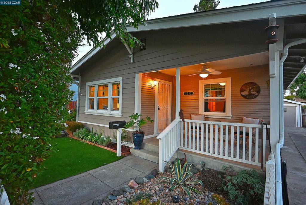 Charming 1920’s Modern Farmhouse Bungalow near Downtown Martinez! This beautifully updated home blends vintage character with modern conveniences. Step inside to find an open living room and dining room with built in cabinetry. The adjacent showstopping light-filled kitchen features quartz countertops, deep blue painted cabinetry with aged gold hardware, a center island, countertop bar range and ample storage. Primary bedroom has walk-in closet and a woodsy-vibe spa-like bath offering shower with white tile & decorative insets & vessel sink. Sparkling hall bath features jetted tub with white tile surround & pedestal sink. Laundry/mudroom has pantry closet and space for 2nd frig. More features: Hardwood floors, vinyl plank in kitchen and baths, recessed lighting, newer dual pane windows, ceiling fans, central heat, and a security camera system. Outdoors, the fenced front yard welcomes you with a synthetic lawn and vegetable garden and a front porch to sit, visit and relax. The backyard is perfect for entertaining or relaxing, offering a synthetic lawn, crushed granite lounging area, raised garden beds, and a storage shed. A detached oversize garage and canning basement offer extra functionality. Close to downtown shops, restaurants & Farmer's Market, parks and the waterfront!