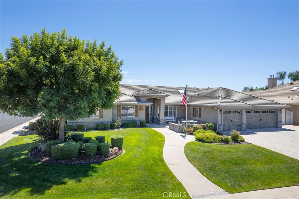 Wathen Mansionette on a Spacious Corner Lot in Clovis Unified!
This beautifully maintained single-story home sits on a generous 12,054 sq. ft. corner lot and offers 4 bedrooms and 3 full bathrooms. The expansive great room welcomes you with a gas fireplace, recessed lighting, ceiling fans, and durable vinyl plank flooring. The gourmet kitchen features granite countertops, a tile backsplash, farmhouse sink, and opens to the family room for easy everyday living. A formal dining room sits just off the main living space perfect for hosting gatherings or special occasions.
Throughout the home, you'll find custom wood cabinetry, crown molding, plantation shutters, and three skylights that bring in abundant natural light. The luxurious primary suite is a true retreat, featuring double-door entry, an oversized closet, quartz countertops, a jetted tub, and a cozy fireplace -your own private spa experience at home.
One wing of the home offers a separate bedroom and full bath, ideal for a guest suite, office, media room, or multi-generational living. The oversized 3-car garage includes carriage-style doors, a workbench, an air-conditioned workshop, and a loft with pull-down stairs for additional storage.
Step outside to enjoy the beautifully landscaped yard, complete with a front patio seating area, Alumawood-covered stamped concrete patio, hot tub, and covered RV parking.