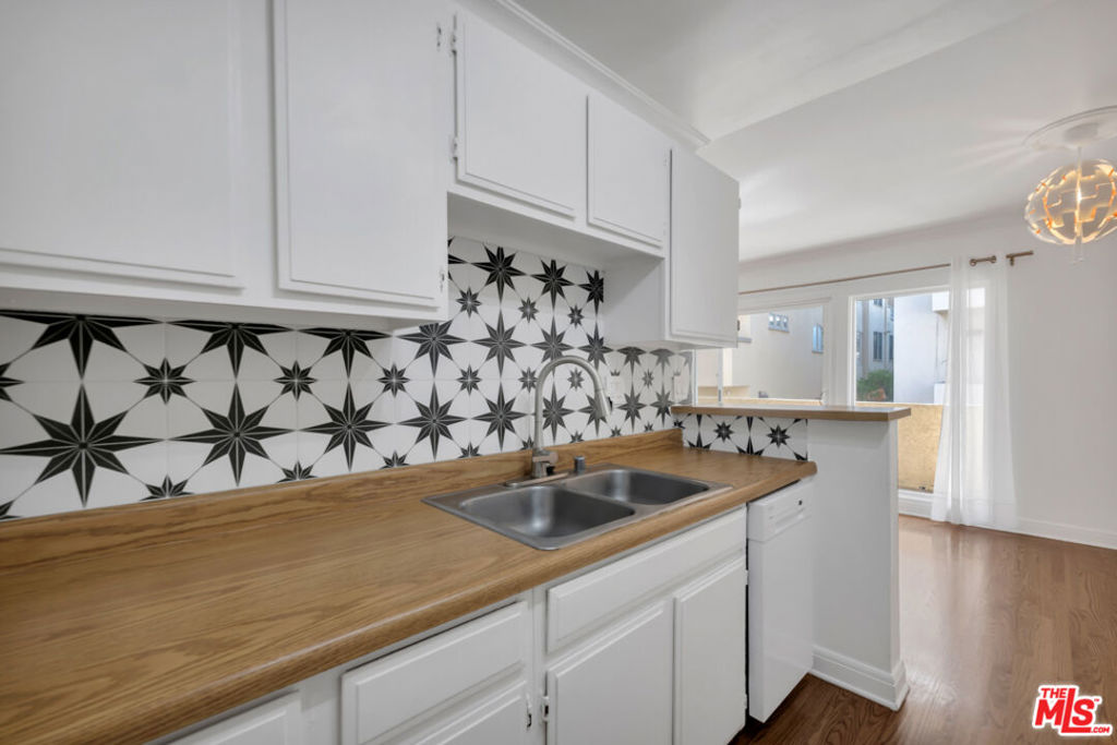 Welcome to this beautifully updated 2nd floor condo nestled in the heart of Brentwood. Located between San Vicente and Wilshire, you'll be just minutes from the neighborhood s best restaurants, cafes, and boutique shopping. Step inside to find elegant wood flooring throughout and a spacious living area that opens to a large private balcony perfect for relaxing or entertaining. The kitchen has been tastefully upgraded with a stylish backsplash and modern appliances, including a dishwasher, microwave, range, and refrigerator. The bathroom features a newer bathtub with a sleek tile surround, a modern shower door and fixtures, and an upgraded toilet and faucet. Enjoy year-round comfort with a newer heater and thermostat, as well as dual-pane windows and a sliding glass door with added tint for privacy and energy efficiency. 1 covered parking space, community laundry in the building.