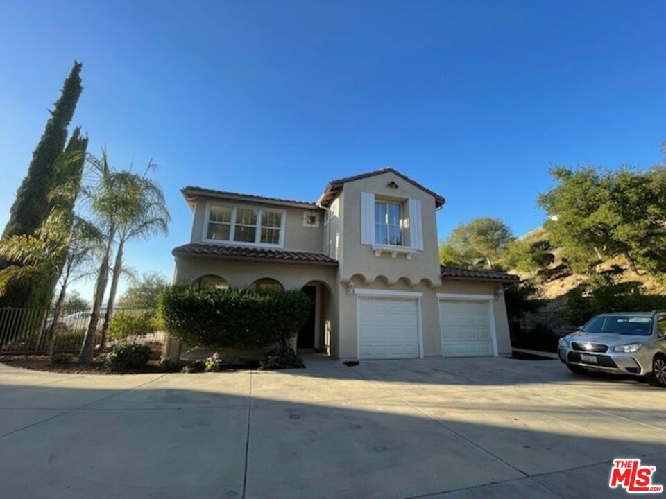 View, View, View! Exquisite Executive Home in Gated Community.  Welcome to this stunning Spanish-style two-story home with breathtaking views from nearly every room! Located in a prestigious gated community in Tujunga, this approx. 3,300 sq. ft. home features 5 bedrooms, 3 full baths, and exceptional living spaces designed for comfort and elegance. Step inside to discover:   * Formal living and dining rooms ideal for entertaining *Gourmet kitchen with granite counters & center island, stainless steel oven, hood, dishwasher & trash compactor, pantry and more.  *Library/office perfect for working from home with stylish built-in shelves.  *Downstairs bedroom with full bath  great for guests or turn it to your gym.  *Separate laundry room and attached garage with custom cabinets.  Upstairs has been freshly painted and features new carpeting throughout. The level includes a luxurious primary suite with dual vanities, a soaking tub, walk-in shower, and custom walk-in closet, plus three additional BRs, a spacious bonus/game room, and a full bath. The exterior has been freshly painted and offers large front and back yards with sweeping views, fruit trees, and occasional visits from local deer outside of the gate in the common area  an ideal space for family gatherings and sunset evenings.  Lovingly maintained by its owners, this home radiates warmth, charm, and positive energy  truly a blessed home ready for its next chapter.                                                                                  Lease option also available at $6,580/month                                                                              One of the owners is Real Estate Agent.
