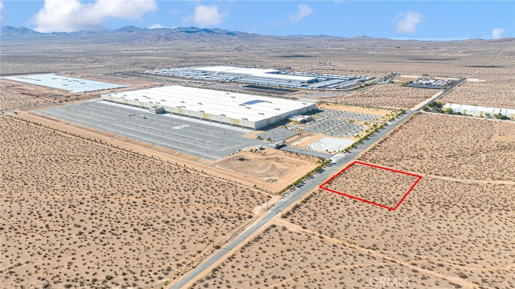 This 2.05-acre corner lot is available for sale, offering a prime location with zoning that supports Industrial use under the Specific Plan designation. Water and sewer utilities are available on-site, and electricity is located directly across the street. Buyer to do their own due diligence. The property boasts 340 feet of frontage along the paved Navajo Rd.
Strategically positioned, the site is located across from the Big Lot Distribution Center and is in close proximity to major distribution hubs like WalMart and Fresenius Medical Care. It's also near the Victor Valley College Regional Public Safety Training Center, further enhancing its appeal.
The area is poised for growth, with Brightline West's recent acquisition of property nearby for a high-speed rail station planned to connect Southern California to Las Vegas. The project is already underway, with construction having begun in Las Vegas.