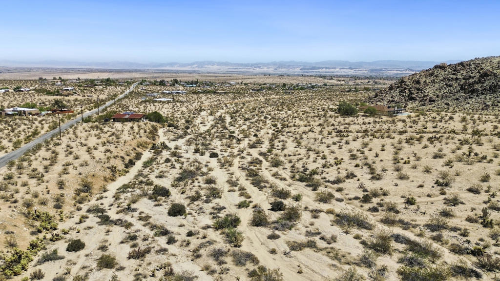 Nestled at the entrance to the 49 Palms Oasis Trail, this 2.11-acre lot on Foothill Drive offers unbeatable access to nature with breathtaking views in every direction. A rare chance to enjoy privacy and serenity without sacrificing proximity to town. Whether you're dreaming of a weekend escape or full-time desert living, this location is truly special.