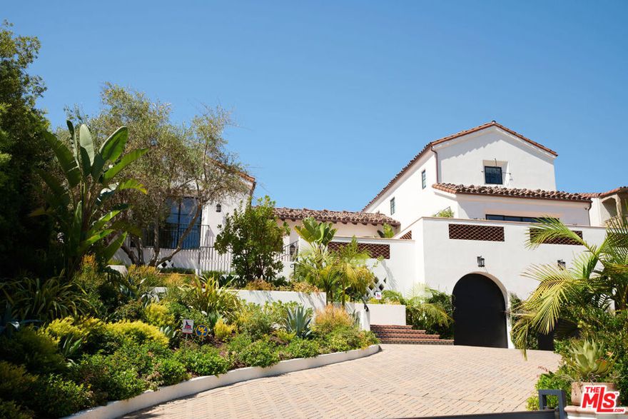 Located in Prime Little Holmby, and meticulously crafted to the highest of standards, this timeless Spanish sits on just over half an acre and totals approx 9,500 square feet. This 6 bed, 5 full 2 half bath home features a voluminous open floor plan and boasts soaring ceilings & walls of glass, effortlessly incorporating indoor and outdoor space. The gourmet chefs' kitchen, that opens to a 500 sqft Loggia, is styled with Calacatta marble, a Lacanche range, upgraded appliances, double island, double dishwasher, custom millwork, and interior design by Charles & Co. The expansive private master retreat offers a lavish bath quarters with free-standing tub, dual sinks, oversized steam shower & generous walk-in closet. Architectural elements include Euroline Steel door and window systems, 150+ year old hand-hewn ceiling beams, hand-troweled walls, solid white oak hardwood flooring, and custom hand-painted tiles throughout. Upgraded amenities include a movie theater, dry sauna, steel plate residential elevator, Crestron smart home, top of the line security system, separate entry en-suite guest bedroom with kitchenette, 5 car garage, and additional space that has been converted to a golf simulator room and extra storage. The site work performed to create a flat back yard paired with the elevation of the home achieves an extremely private and expansive backyard perfect for entertaining, swimming, fireside al fresco dining, and enjoying the best of the indoor/outdoor lifestyle that California has to offer.