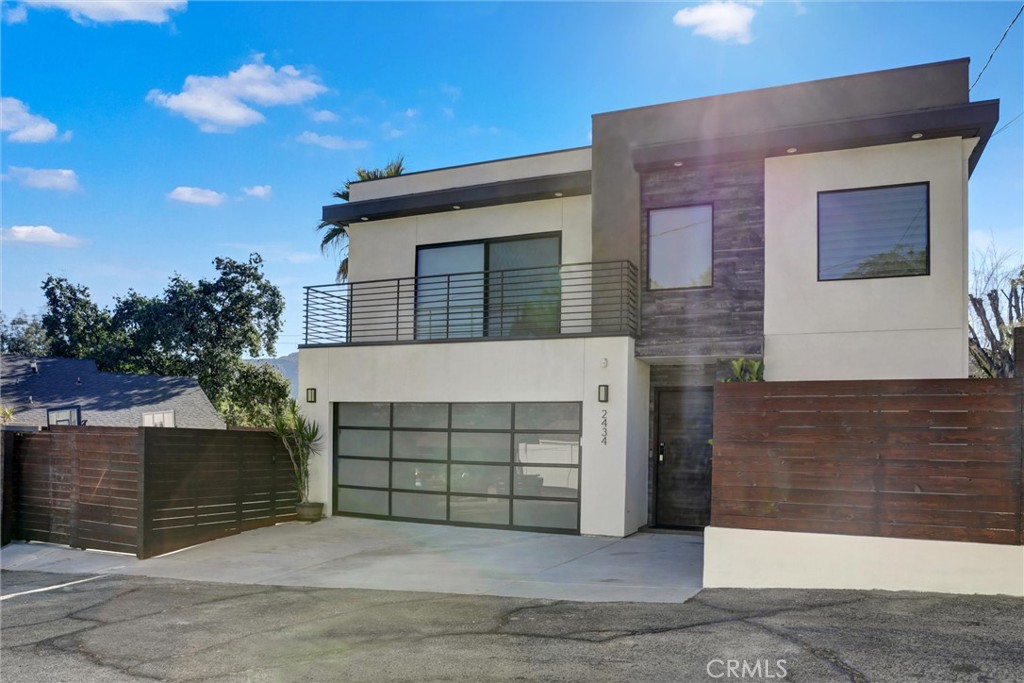 Located in the heart of Montrose—known for its top-rated schools, small-town charm, and vibrant shopping and dining—this newly built contemporary home was thoughtfully designed by the owner-architect to offer both beauty and functionality. Its signature vertical window on the stair landing captures serene mountain views by day and the city skyline by night. The open-concept layout is filled with natural light and features elegant tile flooring throughout the main level. The European-style kitchen boasts a generous island, 36" LG cooktop, oven, microwave, and two pantries—one of which can be converted into a wine rack. A spacious dining area connects to a bright living room with an 86" LG OLED evo TV, a striking dark-toned feature wall, and a modern fireplace. The flat roof design allows for a potential rooftop terrace to enjoy panoramic views. A flexible main-floor room with an adjacent bathroom can function as an office, study, or playroom. Additional built-in storage is located under the stairs. Upstairs, engineered wood flooring adds warmth to the bedrooms and hallway, while the tiled laundry room features a large window overlooking the backyard pine tree. The primary suite offers mountain views, a large walk-in closet designed for two, and a spa-like en-suite bathroom. Two additional bedrooms each have en-suite bathrooms with full showers and scenic views—ideal for guests. Climate control is optimized with a high-efficiency Bosch heat pump for cooling and a radiant floor heating system powered by a Navien tankless water heater, offering room-by-room temperature control and energy savings. The two-car attached garage, plus one driveway spot and two inside a gated side yard, offer up to five total parking spaces. The home is located on a shared two-lane driveway serving four detached homes, providing convenient access with a quiet, residential feel. Low-maintenance rain gardens enhance both the front and backyards. The front yard features a large Trex deck, while the backyard includes a mature pine, bougainvilleas, lemon trees, grapevines, and Benjamin trees, with stepping stone paths creating a private, peaceful garden retreat. Designed with intention, comfort, and architectural style, this home presents a rare opportunity to enjoy elevated living in one of Montrose’s most sought-after neighborhoods.