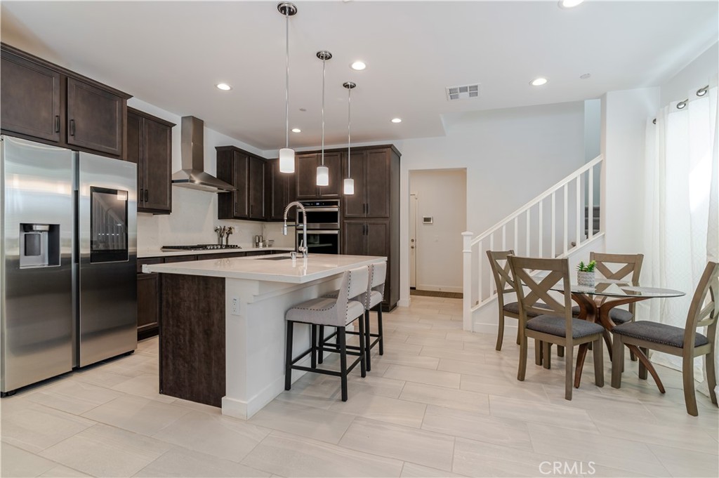 This stunning home, located in the recently built gated community of Grace Park in the heart of Inglewood, is not to be missed. Residents here enjoy resort-style amenities including a sparkling pool with cabanas, relaxing spa, fitness center, community garden, clubhouse, bocce ball court, two children’s parks, and beautifully landscaped grounds. The tri-level home offers an open floor plan with three bedrooms, 3.5 bathrooms, and two private outdoor spaces, perfect for entertaining or relaxing. The attached two-car garage provides direct access to the first floor, where you’ll find a sleek modern kitchen that opens to a patio ideal for barbecuing, along with a comfortable living area. On the second floor, the spacious primary suite features a walk-in closet and ensuite bathroom. Two additional bedrooms, a full bath, laundry room, and a versatile landing perfect for a home office or playroom complete the level. The third floor offers a sun-drenched second living area that flows onto a rooftop patio, complete with a full bathroom, wet bar, and wine fridge, an ideal retreat for entertaining or simply enjoying California’s indoor-outdoor lifestyle. This energy-efficient home features include solar panels, a tankless water heater, programmable thermostat, EV ready garage and LED lighting. With easy access to freeways and LAX, and less than a mile from The Kia Forum, SoFi Stadium, YouTube Theater, Hollywood Park, and Ed Vincent Park, this home offers the perfect blend of elevated living and convenience.