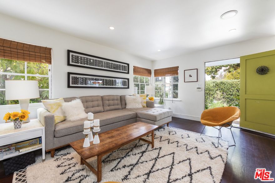 Hidden behind a lush privacy hedge, this modern Venice bungalow lives like a secret retreat. A serene, artfully designed garden ushers you inside to sun-filled living where French doors and windows blur the line between indoors and out. The heart of the home is an updated kitchen and dining area that sets the stage for effortless gatherings and everyday ease. Warm hardwood floors, custom built-ins, and a cozy fireplace define the main living spaces. In the private primary suite, vaulted wood-beam ceilings and leafy views create a calm, restorative vibe, complemented by a spa-like, Zen-inspired bath. Across the garden, a converted garage functions as a versatile studio with kitchenette and bath. It is ideal for focused work, content creation, guest stays, or a quiet study space, thoughtfully separate from the main house. All of this sits moments from the best of Venice, including Lincoln Boulevard essentials and Abbot Kinney's dining, boutiques, and coffee culture, yet tucked away when you want peace and privacy. Price includes both the main house and the converted garage studio.
