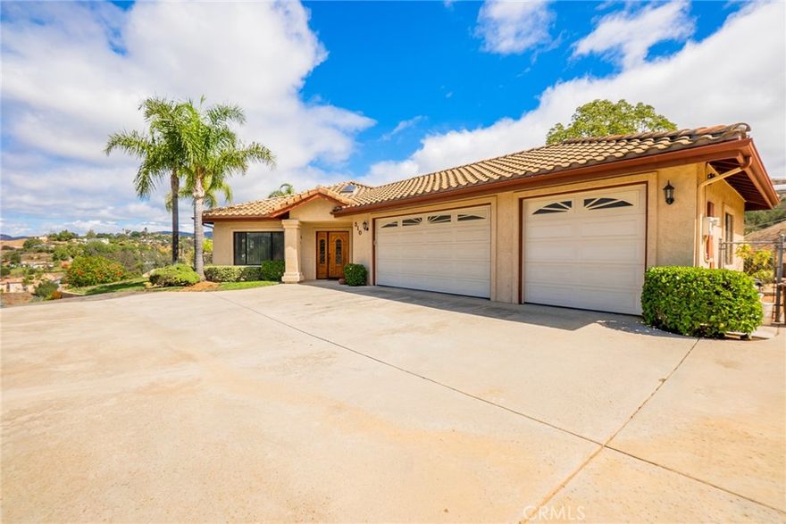 Beautiful single-story custom home on nearly 4.5 acres with stunning mountain and valley views! Approx. 2,740 sq. ft. with 3 beds, 2.5 baths, vaulted ceilings, and open floor plan. Spacious kitchen with island and large dining area. Primary suite offers patio access and spa-like bath. Enjoy peaceful outdoor living surrounded by mature fruit and macadamia trees. 3-car garage plus separate RV garage at the base of the property and PAID-OFF solar! Private, serene setting just minutes from downtown Fallbrook!