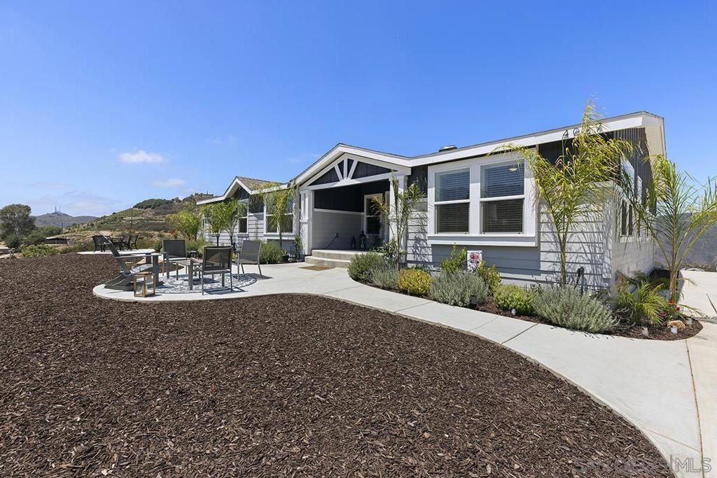 Panoramic views on almost 10 acres only 5 minutes from the 15 freeway! Almost new and move in ready. This home has it all from real hardwood floors, central A/C, vaulted ceilings with architectural elements, an oversized primary bedroom and the list goes on. The electronic gated private entry to the full concrete driveway says it all. 400 amp electrical panel is ready to add more structures such as an ADU, workshop, garage, office, etc. This manufactured home is not your average manufactured home but boasts all the amenities of a conventional build and more. Spacious rooms and a huge kitchen will even accommodate large gatherings. Plans have been submitted for a three car garage with an attached office as well as a two tiered deck facing the west canyon. Two Tuff sheds as well as a 40 foot container convey with the property.