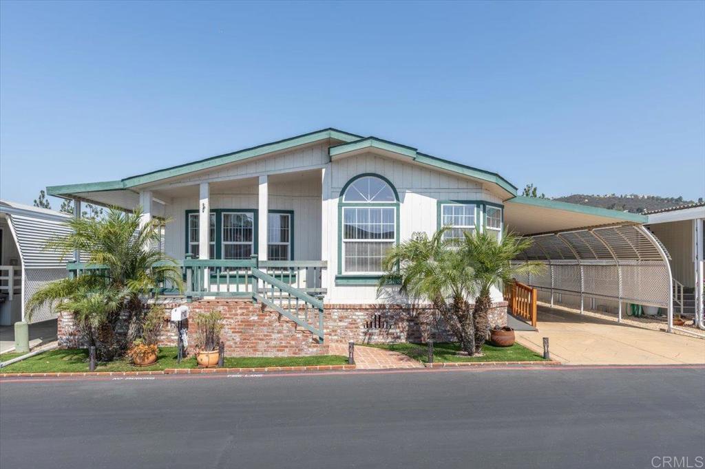 Own your own land & home! No space rent or land lease! 55+ resident owned community! Home has a recorded 433A and therefore qualifies for Fannie Mae, FHA, Reverse Mortgage, and VA financing! Handicap friendly ramp for easy access. This home boasts an open floorplan with lots of natural light! Big Island Kitchen with cheerful breakfast nook area and large pantry with pull out shelves. A formal Dining room is open to a great room style Living room. Two guest bedrooms, one features a murphy bed. Ceilings fans in every room plus lots of solar tubes / skylight for plenty of natural light! The Primary Suite offers a big walk in closet and double sinks. The laundry room features a deep sink and extra storage space. The exterior boats an extra wide carport with privacy screen and stamped concrete, a storage shed, and a lovely wrap around covered deck for relaxing and entertaining. All appliances are included "as is." Madrid Manor is a resident owned, 55+ community w/ a low monthly HOA fee of $222 and plenty of social activities for those seeking an active lifestyle with numerous amenities that include a clubhouse, a Waterfall connecting two ponds and landscaped with walking and hiking trails; pool/spa, BBQ area, tennis/pickle ball courts, ping pong, putting greens, billiard room, card room, library, gym, shuffleboard, korn-hole, car wash area, a studio for dance classes and small meetings, plus a large RV lot for vehicles/boats/trailers and more! Located close to shops on El Norte, as well as Costco, Walmart and Kohls on Nordahl.