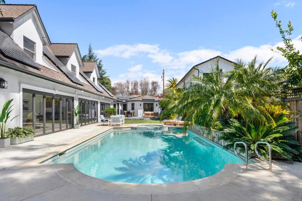 Welcome to 1279 Curtiss Avenue, a stunning Midcentury Modern residence in the highly sought-after Willow Glen area of San Jose. Originally built in 1947 and elegantly renovated in 2025, this home offers a generous 4,100 sq ft of living space on a substantial 10,560 sq ft lot. Boasting 6 bedrooms and 3.5 baths, this residence is designed to accommodate diverse lifestyles. The open floor plan is awash with natural light, enhanced by beautiful hardwood and stone flooring. Relax in the living room by the cozy fireplace or dine in style in the formal dining area. The beautifully appointed chefs kitchen features quartz countertops, a Wolf stove, and stainless steel appliances. the primary suite offers a private retreat with a deck overlooking the lush backyard. Relish the ultimate indoor/outdoor lifestyle with floor-to-ceiling glass doors that open to a private backyard oasis, showcasing a swimming pool, spa, and Tiki Hut bar with BBQ. The garden is perfect for entertaining, complete with a gas fire pit and vibrant fruit trees. Additional features include a 2 car garage, solar panels, dual-zone air conditioning and a convenient laundry room. Enjoy nearby upscale dining and retail stores, plus easy access to the 280 &101 freeways. Discover comfort and style in this neighborhood gem.