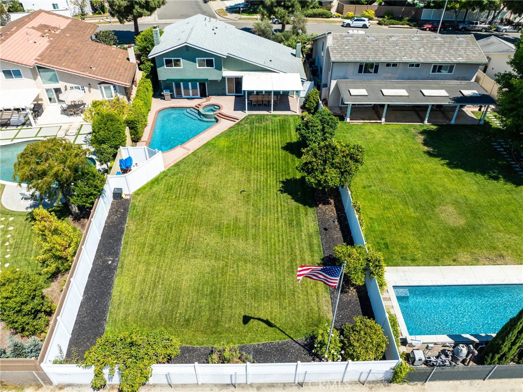 Don’t miss this rare chance to own one of the most exceptional backyards in Costa Mesa. Situated on an expansive 10,000+ sq ft lot, this property offers meticulously maintained landscaping, unparalleled privacy, and endless potential. Whether you're looking to build an ADU or expand the main residence, the possibilities are plentiful.
The backyard is truly a showstopper—featuring a full-size saltwater pool and spa, a spacious lawn ideal for annual wiffle ball tournaments, and easy access to the Santa Ana River Trail, offering easy beach access and refreshing ocean breezes.
Enjoy the bounty of your own personal orchard, which includes a mature olive tree, avocado, Valencia orange, Navel orange, Meyer lemon, Bearss lemon, grapefruit, and plum trees. Say goodbye to the grocery store produce aisle!
Inside, the home boasts a desirable split-level floor plan with generous living spaces perfect for entertaining. You'll find fireplaces in both the living and family rooms, soaring ceilings with updated lighting, and a cohesive design throughout all three remodeled bathrooms. The primary bedroom includes two closets and an oversized balcony for your own private retreat.
Additional highlights include a tankless water heater, a new roof installed in 2024, and proximity to Fairview Park and the award-winning California Distinguished Adams Elementary School. Ideally located between Mesa Verde Country Club and Costa Mesa Country Club, this home offers a unique blend of tranquility, convenience, and lifestyle.
Make this remarkable property the crown jewel of your real estate portfolio.