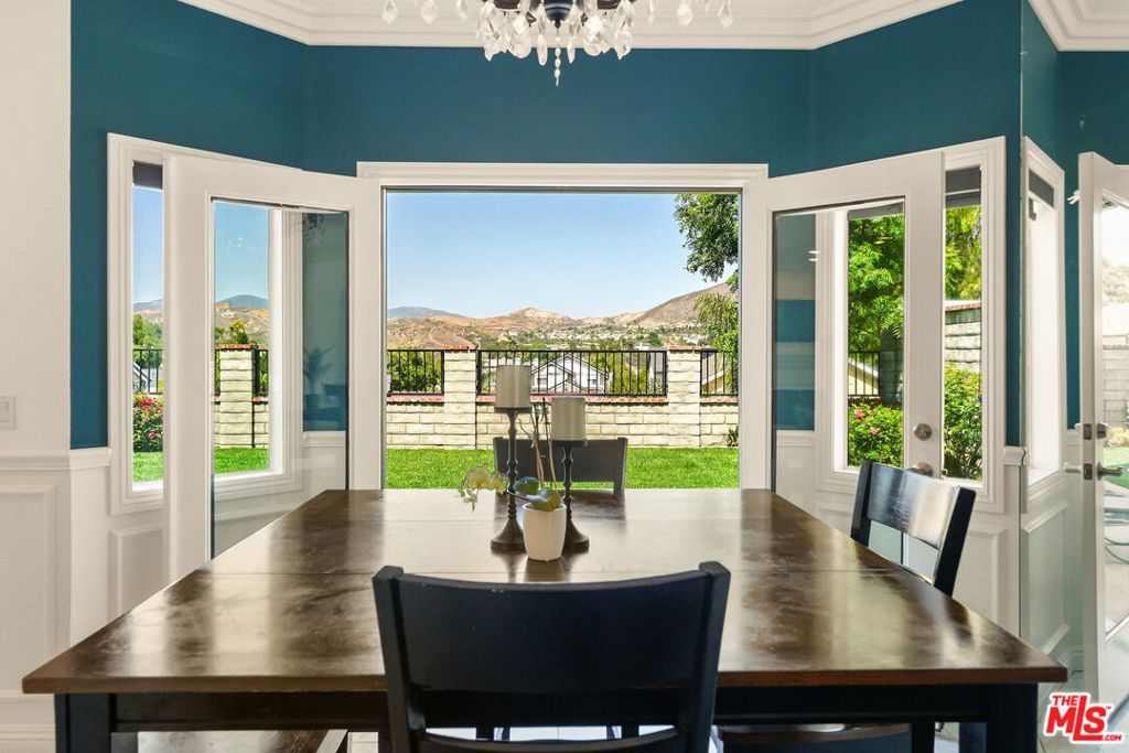 Perched on a premium lot in the highly sought-after Mountain View Cottages tract of Santa Clarita, 22825 Aspen Court is a rare gem that blends design and comfort with something exceptional: unobstructed, panoramic views of the surrounding hills -- a feature enjoyed by only a select few homes in the neighborhood - and fully paid solar panels that generate enough electricity for the current owners to have NO electric bill! Past lush green grass and elegant climbing roses in the front yard, enter into a home that has been lovingly upgraded and meticulously maintained by its owners. Bathed in natural sunlight, the living/dining space features elegant wainscoting, gleaming marble floors, a beautiful crystal chandelier, custom-fit blinds, recessed lighting, and thoughtfully designed built-in Shaker bookshelves and cabinetry. Enjoy meal prep in a kitchen featuring stainless steel appliances, ample storage, breakfast bar, and direct access to the garage and 1/2 bath. From the dining room, new French doors open to the back yard -- dine al fresco on the patio while taking in the million dollar views of the mountains beyond. Upstairs, find three spacious bedrooms and two full bathrooms with high ceilings and views from all rooms. Not only is this home aesthetically lovely with a functional floor plan, it's also energy-smart. The fully paid off panels have allowed the sellers to enjoy the luxury of ZERO electric bills, providing peace of mind and massive long-term savings. A newer AC unit ensures year-round comfort and efficiency. Located on a quiet cul-de-sac, this home offers access to top-rated schools, nearby parks, and convenient shopping -- all while feeling like a private retreat. And as an added bonus, NO Mello-Roos tax or HOA! Don't miss the rare opportunity to own one of the best homes in Mountain View Cottages -- a unique and unparalleled opportunity in the heart of prime Santa Clarita.
