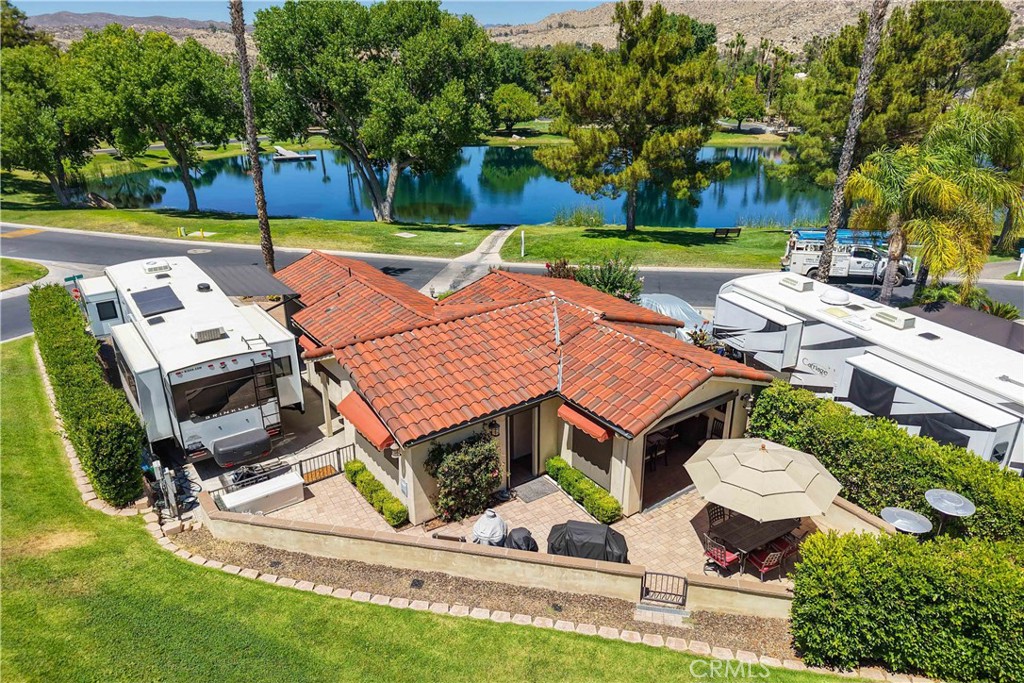 An Absolute Must See Property at the Resort. This Place has Everything - Full Kitchen with Residential Frig, Stove & Microwave w/Granite Counters with Sitting Island, Full and Separate Dining Room with Access to Large Backyard for Extra Dining Area and Privacy Wall/Trees, Step Down Huge Family Room that Leads out to the Courtyard Overlooking the Fishing Pond. You might get Lost in this place, there is even a Laundry Casita with W/D and extra room for the Golf Cart, full Electric Screens throughout the Buildout and lots of Room for Parking Large Vehicles. Huge Grassy Common Area outback and on the Side for Games or even and Easter Egg Hunt, Wait until you see this one. Included in Rancho California RV Resort is a 14 hole Executive Golf Course that is free for owners, 5 Pools and Jacuzzi areas, Tennis Courts, Pickle Ball Courts, Laundry Rooms, Dog Park, Horse Shoe Lawn, Club House, Hiking Trails, and Restaurant all inside Gated Community that is Guarded 24/7. You can live here or rent your space. HOA includes golf, trash, water and common area yard maintenance. Peace and quiet serenity all just 25 minutes from Temecula Wine Country. No age restrictions. Come on over and check this hidden gem of a place out.
