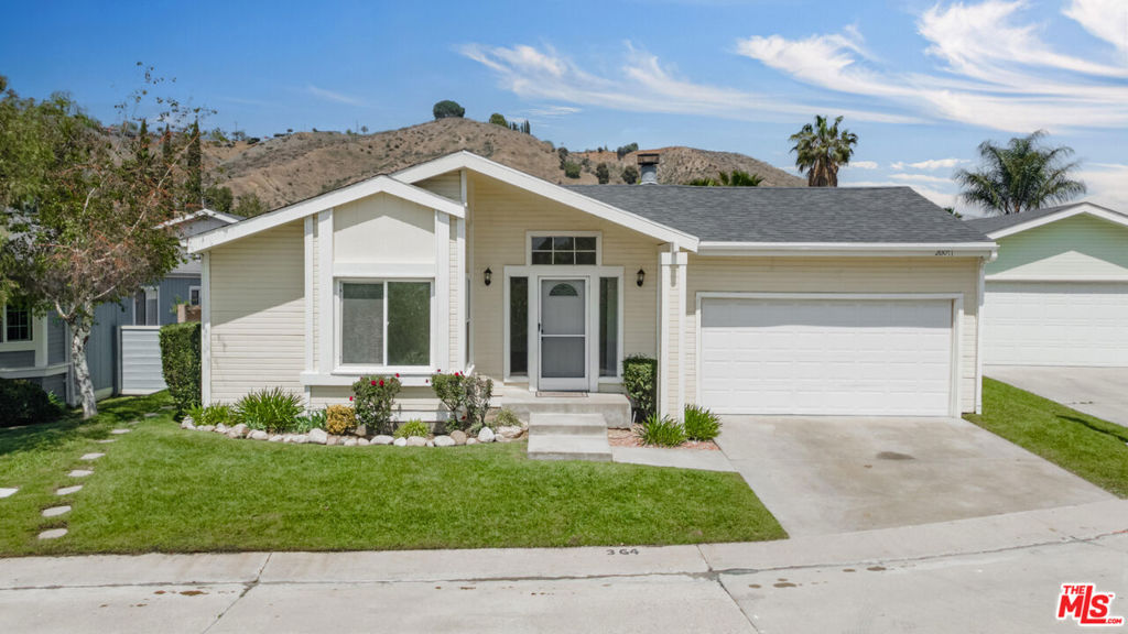 3-Bedroom Home in Secure Gated Community with Stunning ViewsNestled within a desirable gated community with 24-hour security, this updated 3-bedroom, 2-bathroom manufactured home 1,559 sq. ft. of modern comfort and convenience. Complete with an attached 2-car garage, this property is great for those seeking style, space, and serenity.Step inside to a spacious living room featuring vaulted ceilings and a cozy gas fireplace with a hearth, ideal for extra seating or warming up on cool evenings. New luxury waterproof flooring flows throughout the home, enhancing its sleek, contemporary appeal.The chef-inspired kitchen boasts brand-new quartz countertops, modern appliances, and ample cabinetry. The primary suite stands out with soaring vaulted ceilings, two sets of French doors leading to the backyard, and an abundance of natural light. The en-suite bathroom is a spa-like retreat featuring a soaking tub, separate step-in shower, double vanity, and elegant waterproof flooring.Enjoy the convenience of a dedicated laundry room with space for a side-by-side washer and dryer and additional storage.Outside, the private fenced backyard offers hillside views of the local mountainsa picturesque and peaceful setting for entertaining or relaxing with a sunset backdrop.