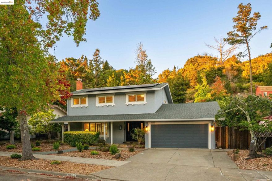 Welcome to 7796 Surrey Ln, a spacious and updated two-story 4 BD, 2.5 BA home laid out in ideal fashion over a generous 2,155 square feet. The main level boasts a stately living room with hardwood floors and a fireplace, a proper dining room, and a sleek kitchen with walk-in pantry. A huge room off the kitchen with a wet bar and second fireplace adjoins laundry and powder rooms, and offers impeccable indoor-outdoor flow thanks to sliding glass doors out to the backyard paradise: enjoy a manicured lawn, wisteria-crowned decks and foliage-framed patios with string lights for ambient evenings, plus fruit trees and plenty of planting beds. Upstairs in the home, four carpeted bedrooms all on the same level near each other make for flexible living options, the primary bedroom featuring an impressive en-suite bath and walk-in closet. An attached 2-car garage with EV charger and built-in workbenches, and an owned solar system round out this thoughtfully designed home. Tucked away on a peaceful tree-lined street in a suburban hub surrounded by East Bay Regional Parks, 7796 Surrey Ln is a comfortable retreat that doesn't sacrifice proximity to amenities and freeways for easy commutes and access to all that the Bay has to offer.