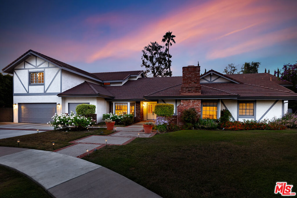 Welcome to this beautiful home, located on a quaint cul-de-sac in the coveted Amestoy Estates neighborhood of Encino. This residence sits on a massive 17,500+ square feet lot that features 6 bedrooms, 5.5 bathrooms, and an expansive floor plan of over 5,500 square feet, blending traditional charm with modern functionality. As you enter, you will be welcomed by stunning wood floors that extend throughout most of the first level. The large family room is adorned with exposed beams and soaring vaulted ceilings, making it the perfect centerpiece for hosting gatherings or enjoying a relaxing evening. The kitchen is ideally situated and showcases beautiful French doors, high-end appliances, a spacious island, and a sizable walk-in pantry. Also found on the first level is a the massive primary suite, which boasts vaulted ceilings, an elegant primary bathroom, and two walk-in closets. Three additional bedrooms, including a custom-built home office/library, complete the first level. The second level features a massive bonus room and houses two additional bedrooms. The backyard is an ideal space for entertaining or rejuvenating, entirely surrounded by mature hedges that provide privacy and ample shade around the sparkling pool and spa. A spacious grassy area can also found in the backyard, perfect a myriad of outdoor activities.