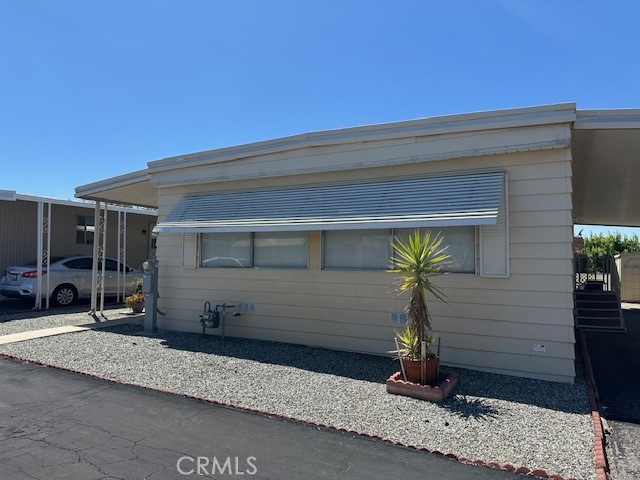 55+ Scenic, beautiful , quiet, Vogue Manor Community. 1 bedroom with a den or office, this large Mobile Home has it all. Complete remodel 6 years ago .Kitchen has all new stainless steel appliances with a refrigerator included. Walk in Pantry with a custom glass door. Cabinets have all been replaced 6 years ago with custom hardware. Island and counter tops are fairly new and the kitchen has that modern flow into the living and dining room area. Washer & Dryer has its own room and is also included in this very affordable home.This home has central heating & air conditioning for year round comfort. There is custom window coverings over the custom blinds. This home has been well maintained and has charm and versatility.