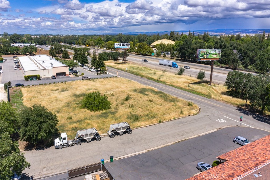 Prime Commercial Development Land with Highway Frontage - Corner Lot at Entler Ave. and Norfield with additional land running along HW 99, total of 1.84 Acres. Develop the corner for your business and utilize the highway frontage for parking, yard area or other use. Exciting path of growth opportunity. The City of Chico is extending its sewer line across the highway through the Subject Property (Easement - Should not affect use of property) There are Billboards on the highway frontage portion of the premises. Seller to retain ownership of Billboard Sign Easements and Billboard Leasehold Estates unless by separate agreement. Owner will consider a Build to Suit. Zoned LI - Light Industrial - Permitted uses in the LI zone include construction, maintenance and repair services; equipment sales and rentals; vehicle repair, service and maintenance; research and development; light manufacturing; and warehousing, wholesaling and distribution and emergency shel-ters. Limited amounts of retail, personal services, restaurants, and public/quasi-public uses are permitted to serve area workers, and ancillary retail areas are permitted for the sale of products manufactured on-site.