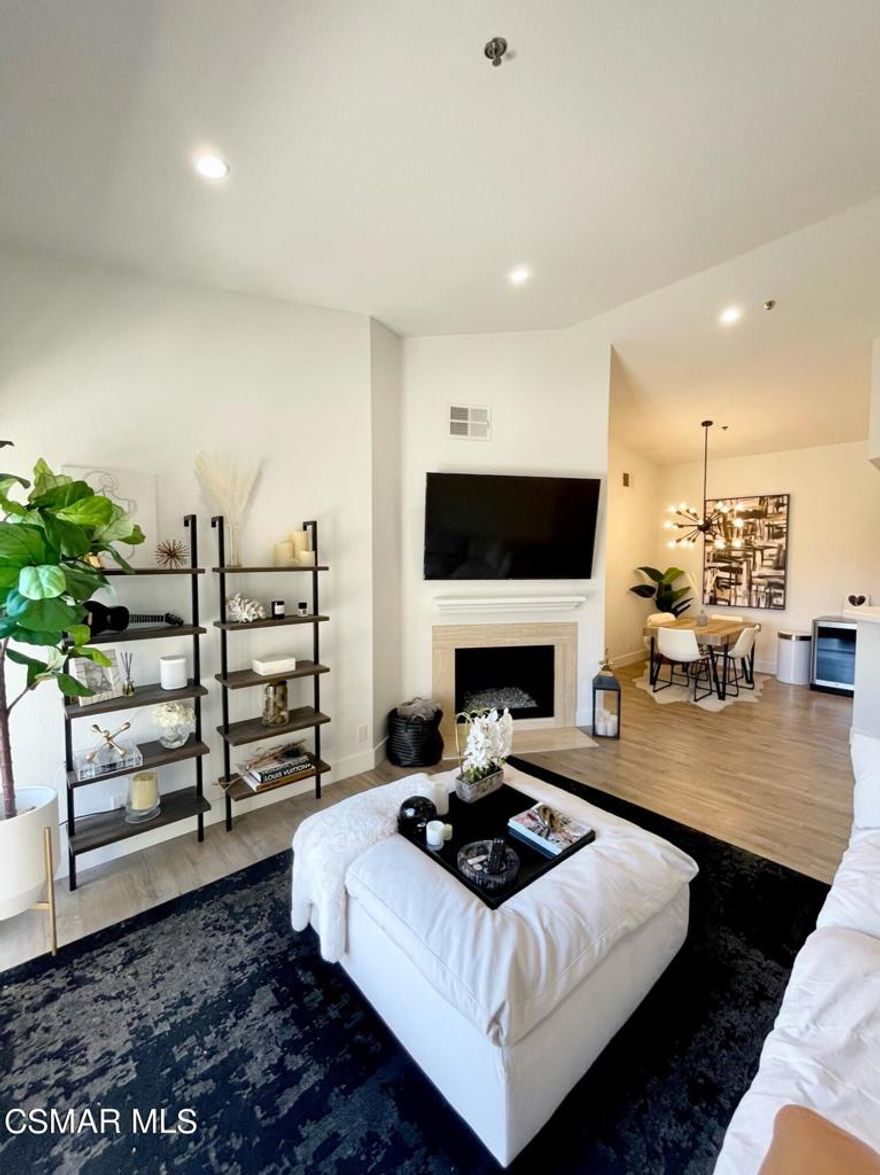 Welcome to this beautifully remodeled (just in 2019) open floor plan condo, located on the top floor offering an abundance of great natural lighting as well as the gorgeous mountainside view. Upon entry you are greeted with neutral, plank flooring, recessed lighting, high 20ft+ ceilings and smooth ceilings create a nice sense of space.  The one bedroom suite features a large walk-in closet with organizers and slider access to the patio where you can unwind and take in the lush green scenery.  The bathroom has been completely gutted and remodeled and features a large stall shower, marble stone topped vanity, an LED backlit vanity mirror and a chic barn door closure. The fireplace also has been updated for a fresh, modern look.  You'll be hard pressed to find a better location than this.  The balcony floor and railing were redone by the HOA in 2021.  The spacious balcony also features a storage closet with washer and dryer.  Internet and cable are included along with a Nest smart thermostat and Nest camera doorbell that can be controlled with the Nest app. Shadow Ridge is located close to Oak Park schools, hiking trails and a dog park.  Take advantage of the incredible resort-like amenities included with this stunning community. Enjoy the private lush walkways, or a game of volleyball, tennis or basketball on the sport courts. Gym amenities also included. Bask in that So Cal sunshine too at either of the 2 community pools and spas. Includes one deeded covered parking spot plus additional guest parking.