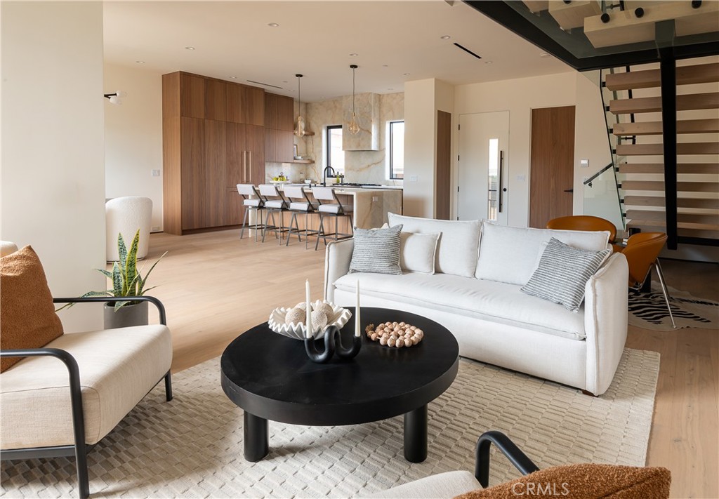 Nestled between Silver Lake and Echo Park, this 2025 new-construction tri-level by Blackstar Capital blends vibrant city living with modern luxury across 4 bedrooms and 3.5 bathrooms. Sunlit, airy interiors showcase soaring ceilings, expansive glass, and seamless indoor–outdoor flow, anchored by a showpiece chef’s kitchen with custom European-style cabinetry, Onyx quartz stone surfaces, and premium panel-ready appliances. The serene primary suite offers a spa-like bath and customized walk-in closet, while secondary bedrooms flex for family, guests, or a home office. Ascend to the private rooftop deck for sweeping city and DTLA skyline views—perfect for golden-hour dinners or stargazing—and find rare versatility in the separate ADU with its own private entrance and full kitchen, ideal as guest quarters, a creative studio, or an income-producing rental. Elevated finishes throughout—wide-plank hardwoods, bespoke millwork, and designer lighting—set this home apart, all moments from Sunset Boulevard’s cafes, restaurants, the Reservoir, and neighborhood hotspots.