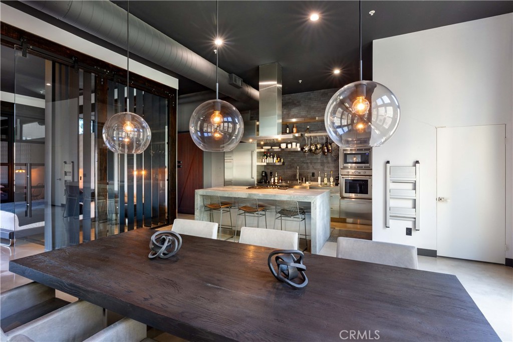 Discover modern luxury in this 2-bedroom, 2-bathroom residence at The Artist Walk Lofts community, set in the heart of Downtown Santa Ana’s thriving Arts District and Artists Village. Fully transformed in 2014, this home combines architectural style with premium upgrades for a one-of-a-kind living experience.
Spanning 2,327 sq. ft., the residence is thoughtfully designed across three levels. The first floor features a flexible space—perfect for a private office, gym, or studio—along with an attached garage. The second floor offers a sultry, lounge-inspired retreat with designer lighting, while the third floor captivates with soaring ceilings, an open-concept living area, and a chef’s kitchen outfitted with Thermador appliances.
Every detail showcases craftsmanship and luxury: California Faucets, Lacava sinks, and modern wall-mounted Toto toilets elevate the bathrooms, while Oxford Marazzi tiles and polished concrete floors create a sleek, cohesive aesthetic. A dramatic 10-foot custom glass door separates the primary suite from the living space, where a spa-like bath, private balcony, and abundant natural light complete the retreat. Additional upgrades include a Water Boss water softener and an efficient tankless water heater.
Furnished throughout with curated Restoration Hardware pieces, this home offers a turnkey opportunity in one of Orange County’s most dynamic neighborhoods. Located just steps from renowned dining, bars, shops, and the monthly Artwalk—with quick access to the 5 Freeway and public transit—you’ll enjoy both convenience and culture at your doorstep.
Whether envisioned as a live-work space or a refined city sanctuary, this home delivers the perfect blend of style, function, and urban energy.