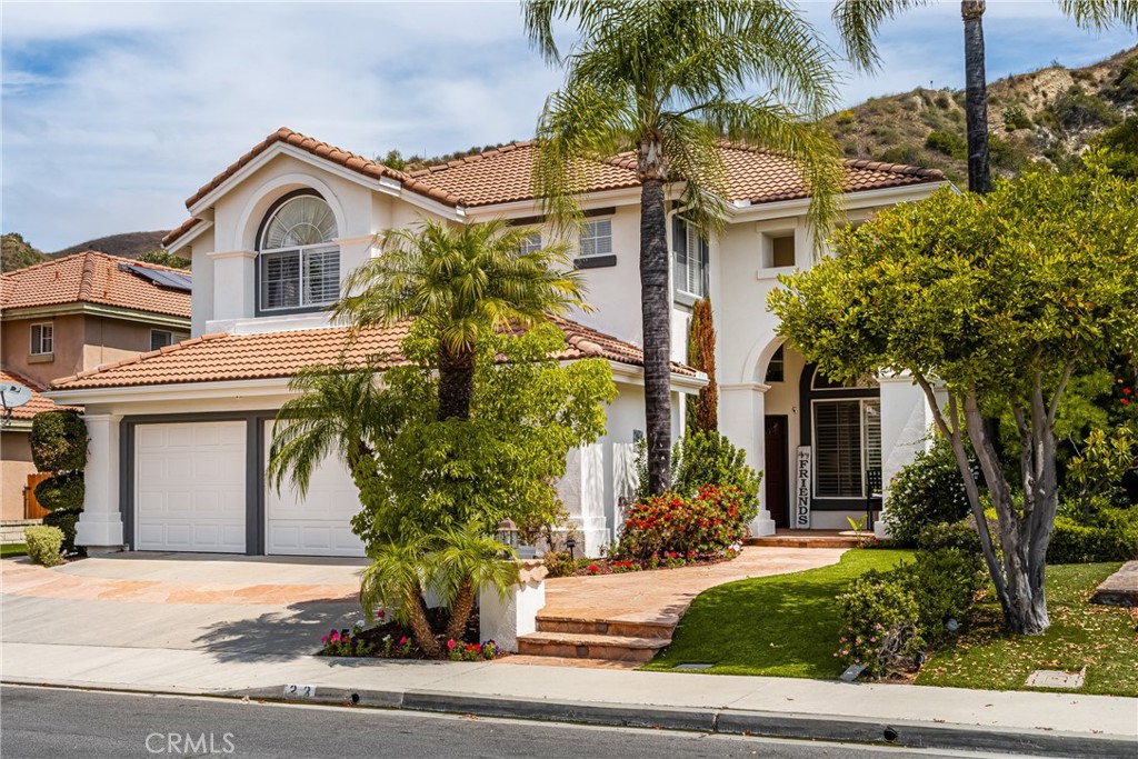 Live the Southern California lifestyle you've always dreamed of in the enchanting community of Foothill Ranch, surrounded by picturesque rolling hills. This premier location features a resort-style backyard designed for unforgettable entertaining, complete with a sparkling pool, spa, built-in BBQ, cozy firepit, and a covered patio for outdoor dining, as well as a large side yard, all backing to a lush hillside with loads of privacy. This stunning pool home boasts charming curb appeal and a versatile, light-filled floor plan. Just minutes from the Irvine Spectrum, featuring five spacious bedrooms, three bathrooms, and 2,647 sqft of comfortable living space. At the heart of the home is a remodeled chef's kitchen, featuring an oversized center island, quartz countertops, custom glass backsplash, custom cabinetry, stainless steel appliances, a double oven, custom vented hood, wine cooler, and a work station. The adjoining family room, featuring a cozy fireplace with an upgraded mantel, is perfect for relaxing or family gatherings. The main level features a convenient downstairs bedroom and full bathroom, ideal for guests or a home office, as well as a laundry room and three-car garage. Upstairs, the expansive primary suite includes a peaceful sitting area, high-volume ceilings, a remodeled bath, dual vanities, a separate shower enclosure, a soaking tub, and a large walk-in closet. Three additional bedrooms share a secondary bathroom. Additional upgrades include newly painted interior, new luxury vinyl flooring, plantation shutters, and two zoned a/c.