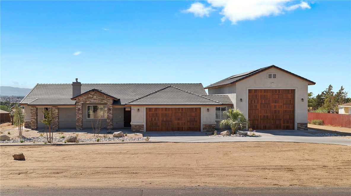 Welcome to this stunning new construction home in the highly desirable city of Apple Valley, offering the perfect blend of modern luxury and functionality. Situated on a spacious 1-acre lot, this home spans approximately 2,100 sq. ft. of living space with 3 bedrooms, 2.5 bathrooms, and a versatile bonus room. The property is designed for both comfort and convenience, featuring quartz countertops throughout, a spa-inspired master suite with a free-standing soaking tub, walk-in shower with dual shower heads, and elegant finishes at every turn. Car enthusiasts and RV owners will be amazed by the nearly 2,000 sq. ft. of garage space, which includes a 25' x 48' RV garage with full RV hookups, dog wash station, and even a urinal. For year-round comfort, the RV garage is equipped with hookups for two mini split units. This home also comes with paid-off solar panels, providing both energy efficiency and peace of mind. Outside, you’ll find a massive 46' wide finished patio with three ceiling fans, perfect for entertaining or relaxing. The entire property is surrounded by a concrete walkway, complemented by professional landscaping with automatic timers and accent lighting. This property truly offers it all—modern living, energy efficiency, and plenty of space for your toys, hobbies, and gatherings.
