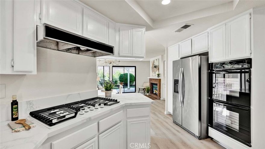 Experience the pinnacle of Chino Hills living in this stunningly remodeled residence, where over $100,000 in upgrades have transformed this property into a modern sanctuary. Nestled against the untouched beauty of Chino Hills State Park, this home boasts unobstructed panoramic views of rolling hills, wildlife, and endless skies—providing both privacy and serenity that can never be built over.Step inside to a light, bright, and airy floor plan adorned with soaring vaulted ceilings, expansive windows, and new vinyl plank flooring throughout the lower level and staircase. The heart of the home is the oversized living room with a dual-sided brick fireplace, nicely flowing into a formal dining room with designer chandelier, and a large separate family room w/breakfast nook.The showstopper is an updated chef’s kitchen featuring quartz counters, quartz backsplash, stainless steel farm sink, Whirlpool five-burner cooktop, dual Frigidaire ovens, and a large walk-in pantry with pullouts. This also has what every buyer is looking for: A spacious downstairs bedroom with adjacent full bath which makes for the perfect guest or in-law suite.Upstairs, retreat to your luxurious master suite (16’ x 14’)—a private haven with vaulted ceilings, double-wide closet organizers, a romantic tiled fireplace, and its own balcony with composite decking. From here, savor morning coffee as you watch birds and butterflies drift across the hillsides. The spa-inspired master bath impresses with a glass walk-in shower featuring subway tile and designer tile flooring, a soaking Jacuzzi tub,and dual sinks with modern fixtures.Two additional spacious bedrooms (12’ x 10’) share a stylish Jack & Jill bathroom with dual sinks and upgraded finishes.Additional highlights include: Brand-new HVAC system, indoor laundry room with overhead cabinetry (washer & dryer included),Two-car garage with built-in storage,Mature landscaping with adobe tile entry walkway,blooming flowers,and palm trees,Freshly painted interior and exterior,Gated front sitting area surrounded by flowers,Concrete tile roof for durability. The backyard is a private sanctuary, offering a covered patio, multiple sitting areas,and breathtaking sunset views over the park’s rolling hills.With no neighbors behind,you’ll enjoy the peace of nature in your own personal retreat.This rare property combines modern elegance, thoughtful upgrades, and one of the most coveted views in Chino Hills. Don’t miss the chance to make this dream home yours!