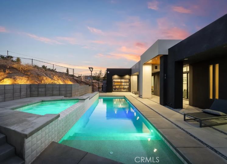 KING OF THE MOUNTAIN! Come and see this stunning modern retreat in Yucca Valley.
Discover this exceptional 21-acre property, a true oasis that combines luxury and comfort in the heart of the desert. Spanning an impressive 2,089 square feet, this modern build boasts three spacious bedrooms and three beautifully appointed baths, making it ideal for families or anyone seeking a serene getaway.
Step inside to find high ceilings that create an airy ambiance throughout the open kitchen and living areas. The kitchen is designed for both functionality and style, perfect for entertaining or enjoying quiet evenings at home. Cozy up by the fireplace in the living room, providing warmth and a touch of elegance during cooler desert nights.
For fitness enthusiasts, the expansive garage includes a dedicated gym space, allowing you to maintain your workout routine without ever leaving the property. The three-car garage offers ample storage and convenience.
Outside, indulge in your private in-ground pool and spa, perfect for cooling off during hot summer days or unwinding under the stars; surrounded by privacy fencing perched on top of a mountain. The stunning mountain views and unique desert landscape enhance the already picturesque setting, providing a truly tranquil experience.
This property is not just a home; it’s a very successful vacation rental, making it a fantastic investment opportunity. Whether you're looking to escape to the desert or seeking a profitable venture, this Yucca Valley gem has it all.