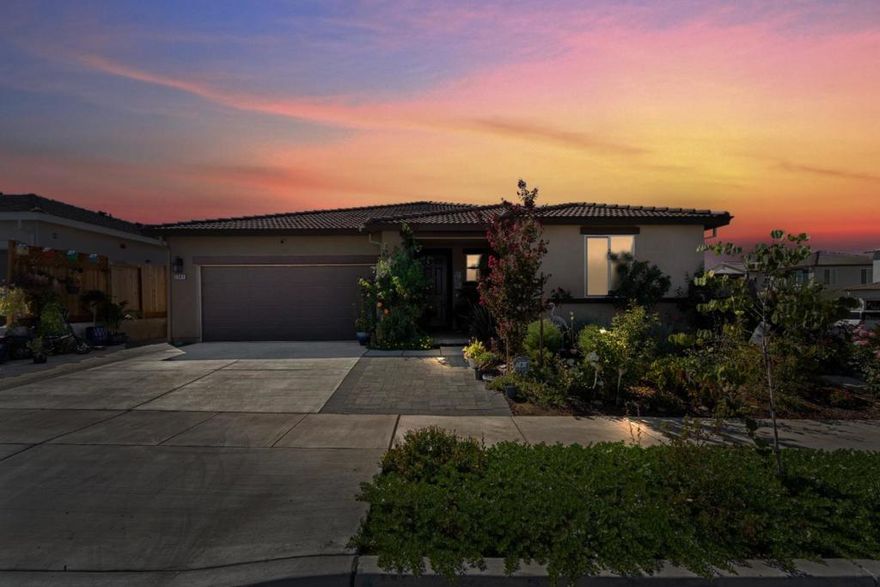 Welcome to 2141 Wildflower Drive! This beautifully maintained corner-lot home offers modern living in one of Hollister's desirable newer neighborhoods. Featuring 4 spacious bedrooms and 2.5 bathrooms, the open- layout seamlessly connects the kitchen, dining, and living areas perfect for both entertaining and everyday comfort.  The kitchen boasts a generous layout with plenty of counter space and cabinetry, flowing naturally into the main living area. Outside, enjoy a private patio that provides an inviting space for relaxing, dining, or gatherings. Energy efficiency is front and center with leased solar panels and two Tesla backup batteries, giving peace of mind and significant savings. The property is also home to multiple rescue animals, showcasing its warm and welcoming environment. With its prime corner location, newer construction, and thoughtful upgrades, this home blends convenience, sustainability, and comfort ready for its next owners to make it their own.